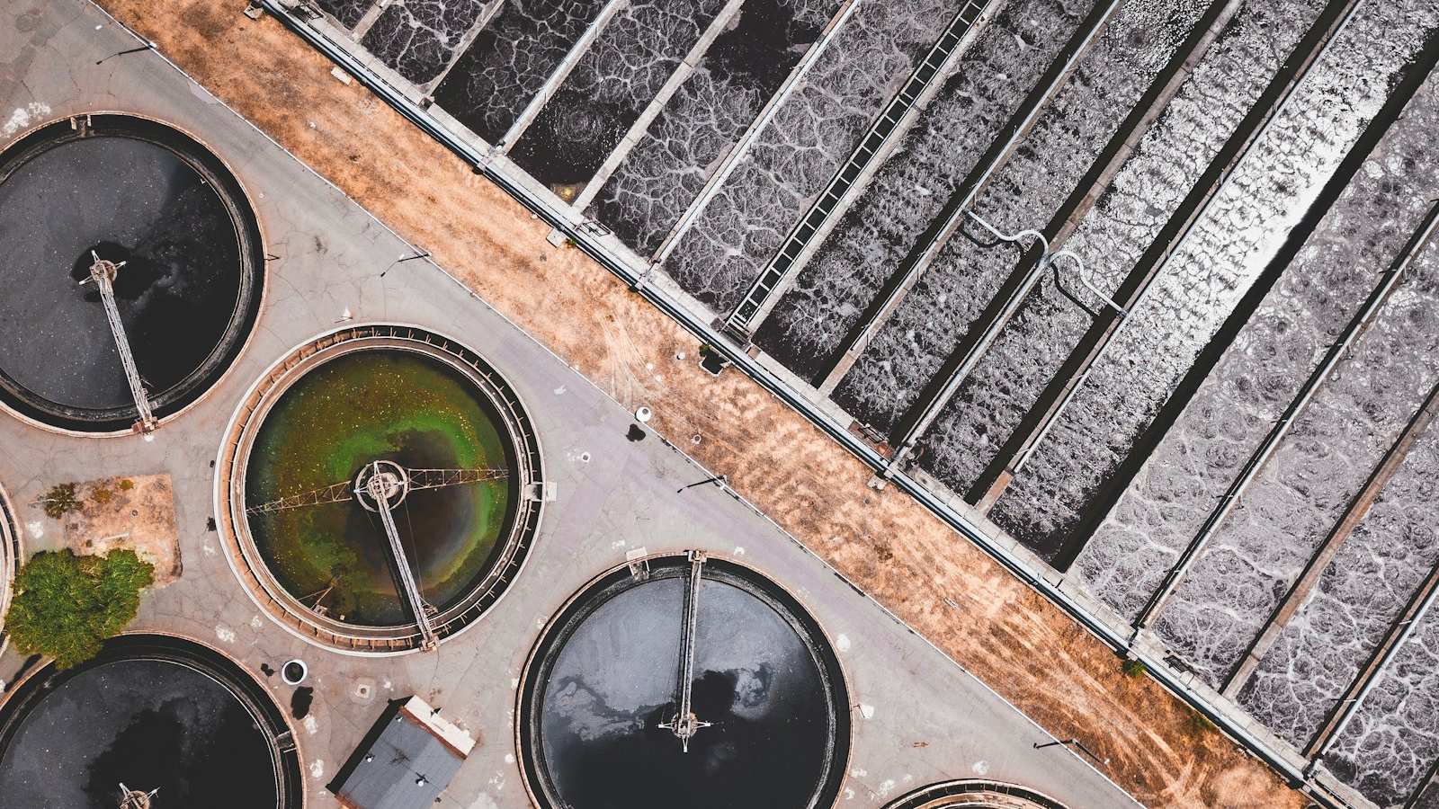 Industrial digestion tanks and process piping at a wastewater plant, the equipment central to anaerobic digestion for sludge at industrial plants