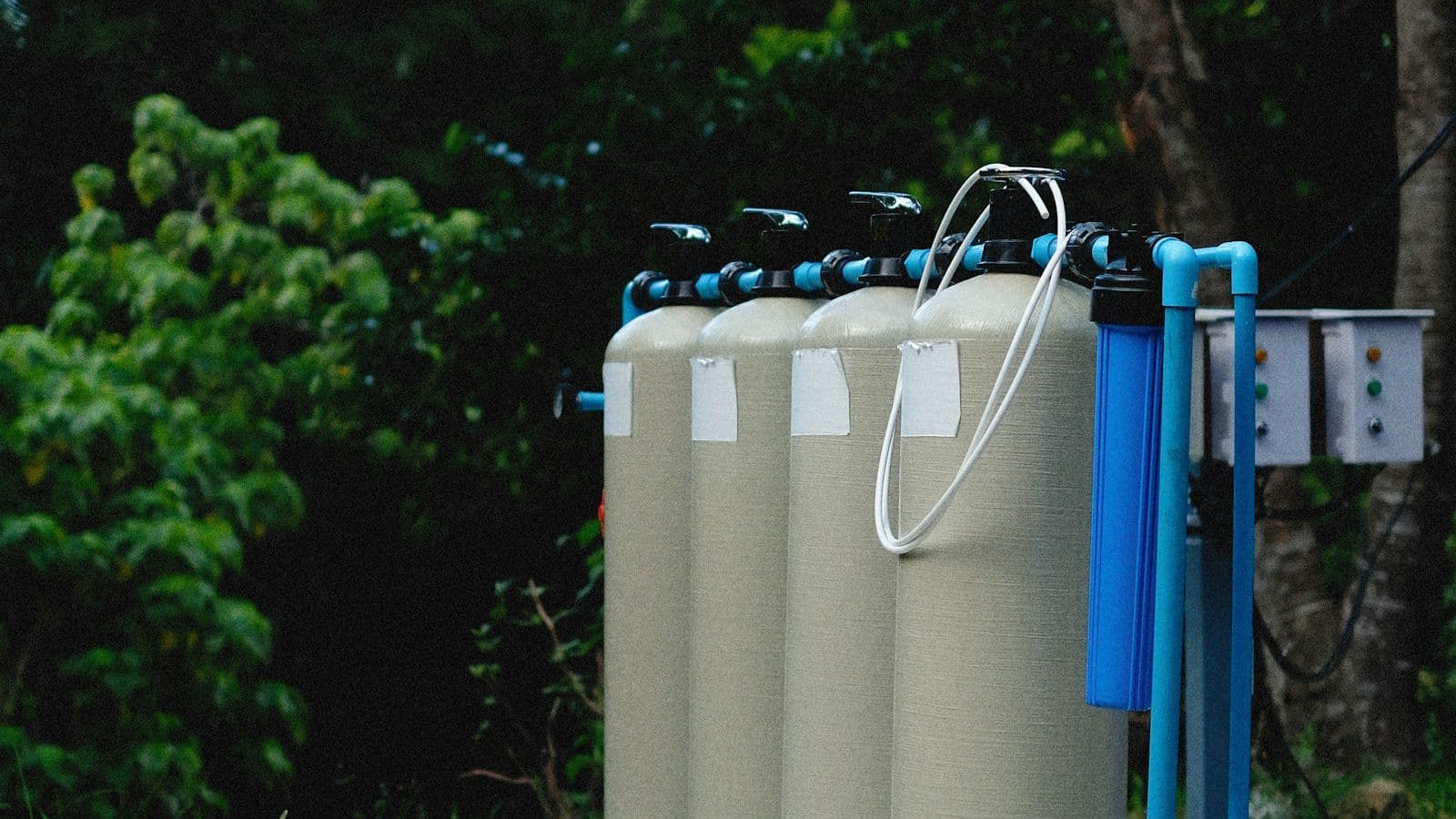 Industrial filtration vessels and process tanks lined up in a row, representing the membrane-skid infrastructure where the ceramic vs polymeric material decision plays out