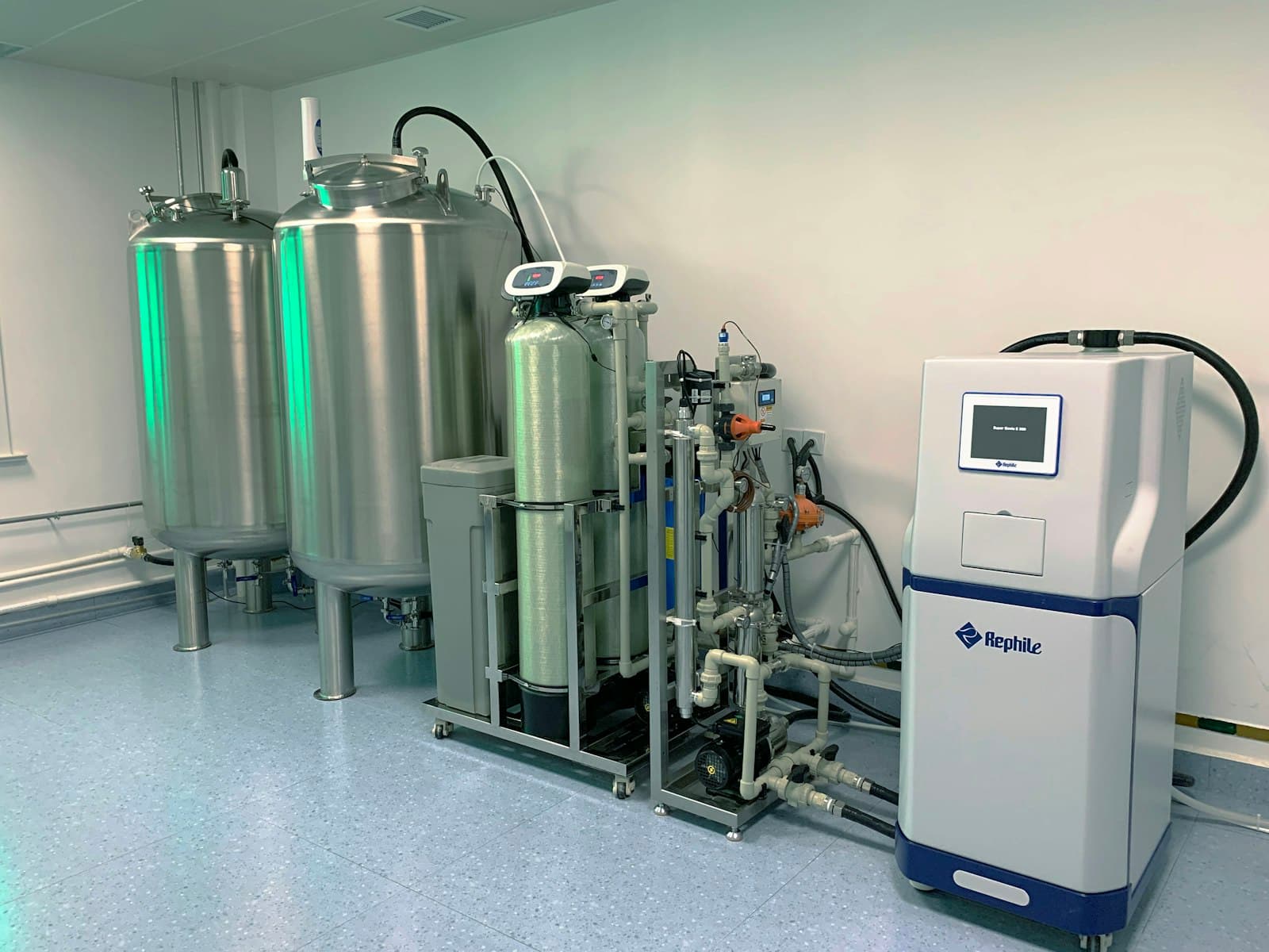 Stainless steel dosing skid with storage tanks and control cabinet for automated chemical injection