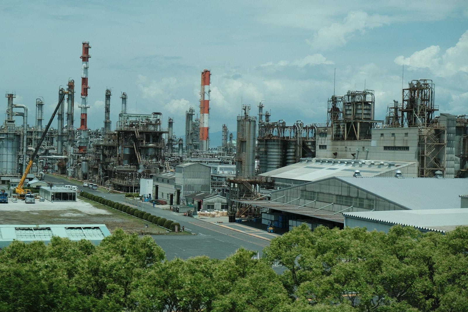 A large chemical and petrochemical processing complex with distillation columns, reactors, and storage tanks
