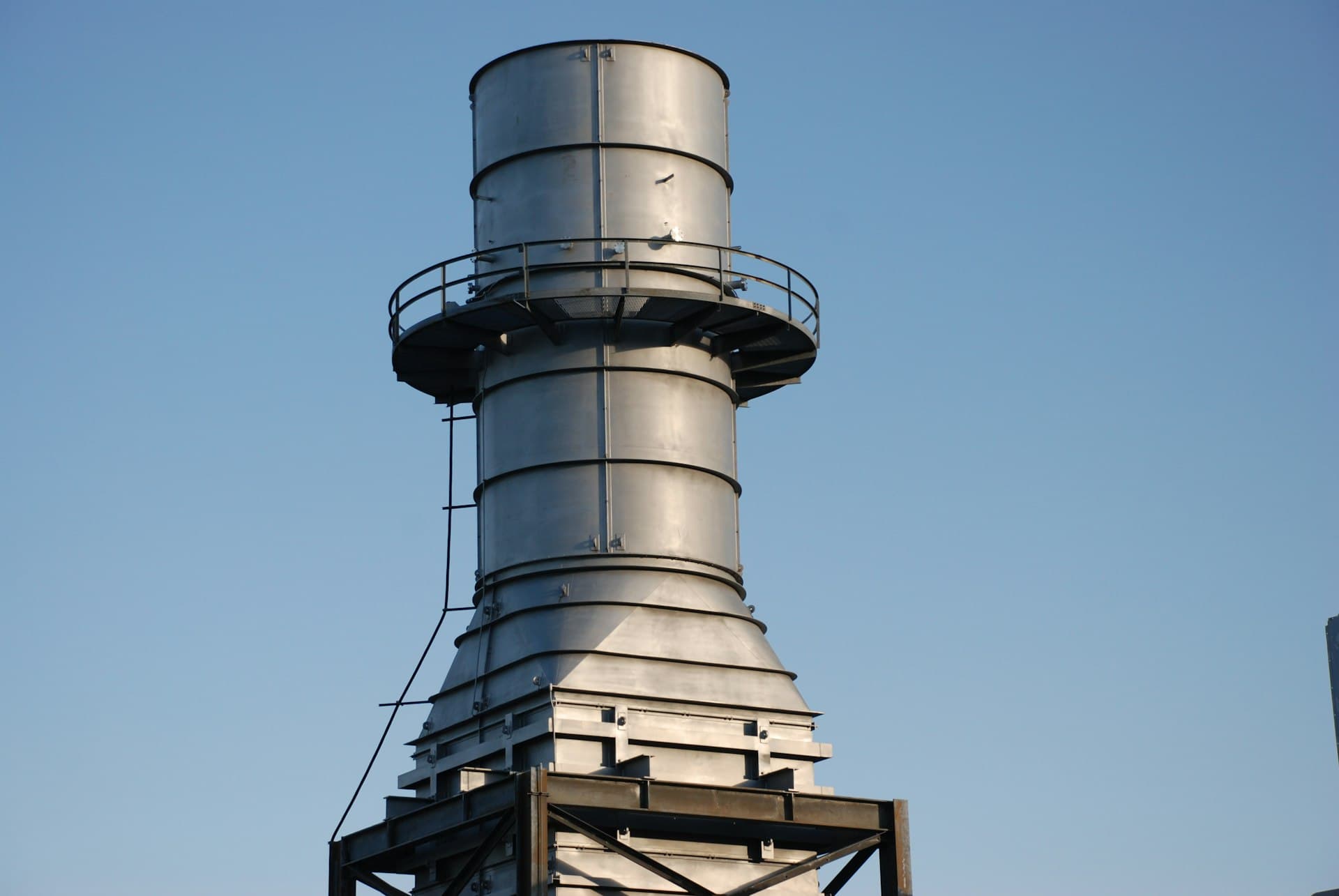 Mechanical-draught cooling tower cell on a rooftop, where cycles of concentration set the water bill