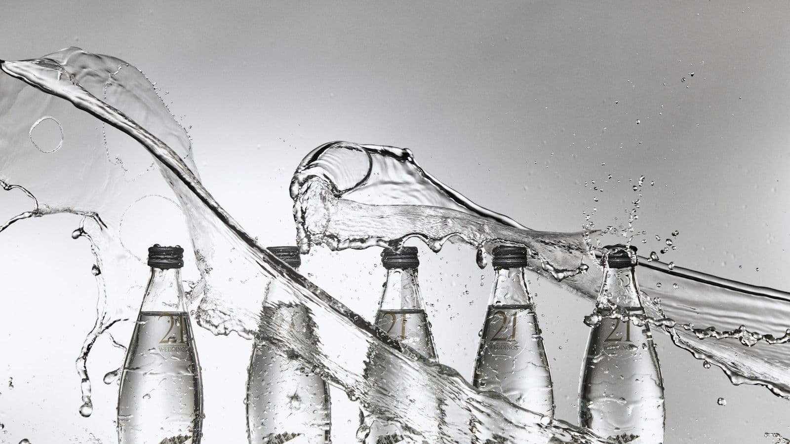 Bottled water on a filling line with a wave of process water — product quality starts with treated water