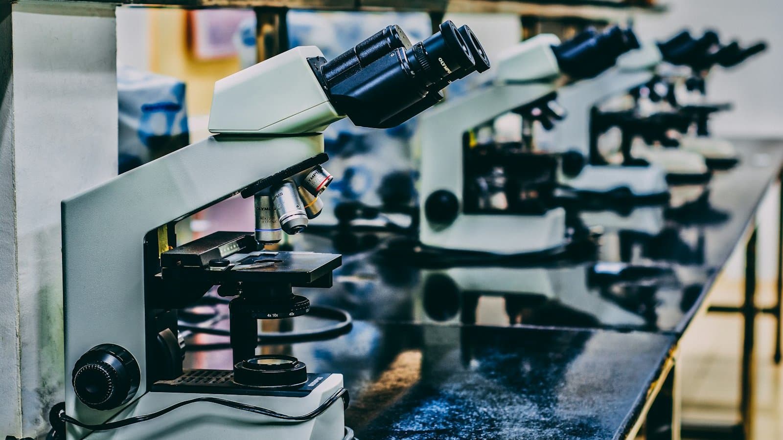 Scientific microscope on a laboratory bench representing the bench-scale research environment where graphene water filtration chemistries are developed before scaling to industrial pilots