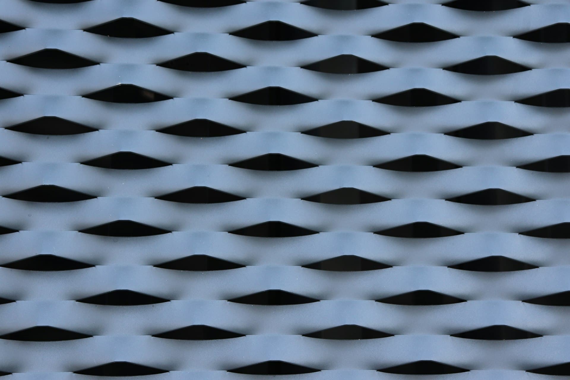 Close-up of an expanded metallic lattice pattern reminiscent of graphene’s atomic mesh