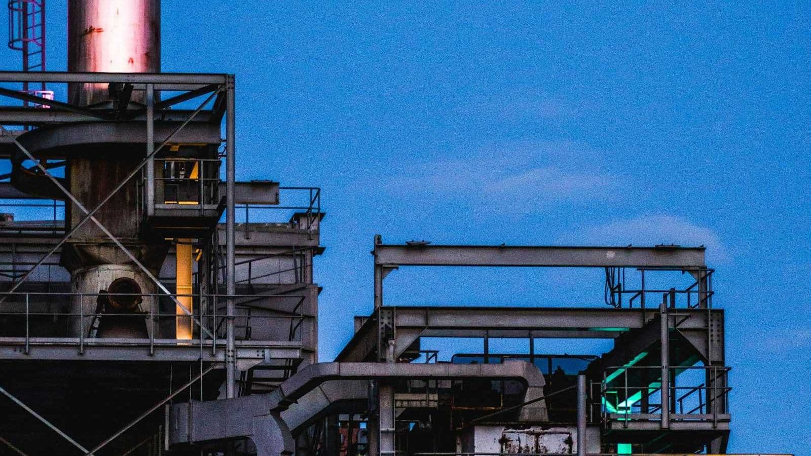 Black metal industrial factory building exterior, the kind of commercial and industrial property where HVAC water treatment compliance under L8 is a legal obligation