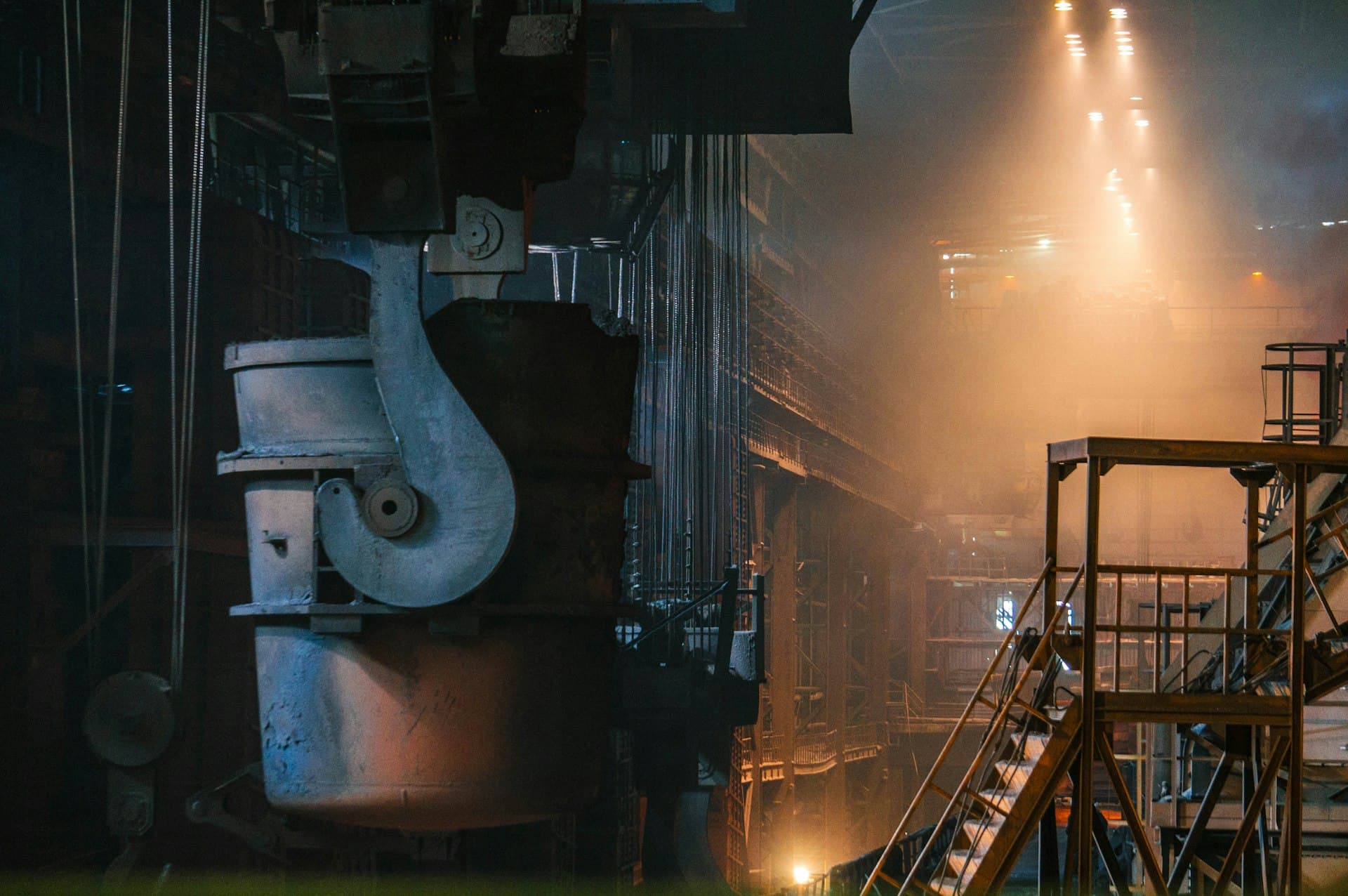 Steam rising around boiler-house piping at night — scale and corrosion control keep this plant alive