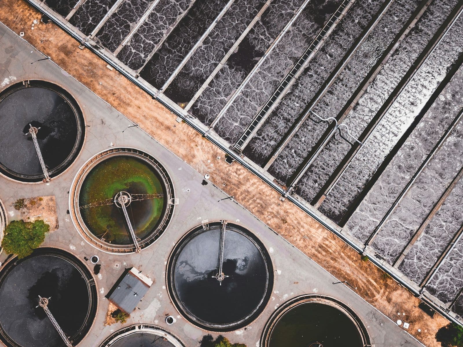 Aerial view of clarifiers and aeration lanes laid out in process sequence at a treatment works