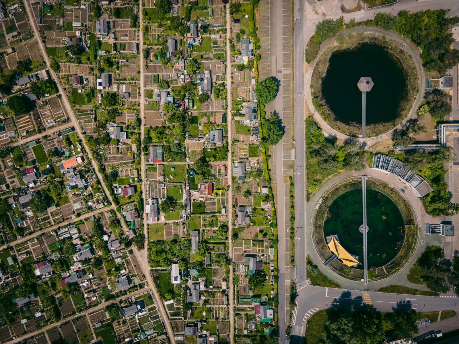 Aerial view of a wastewater treatment works ringed by circular clarifiers