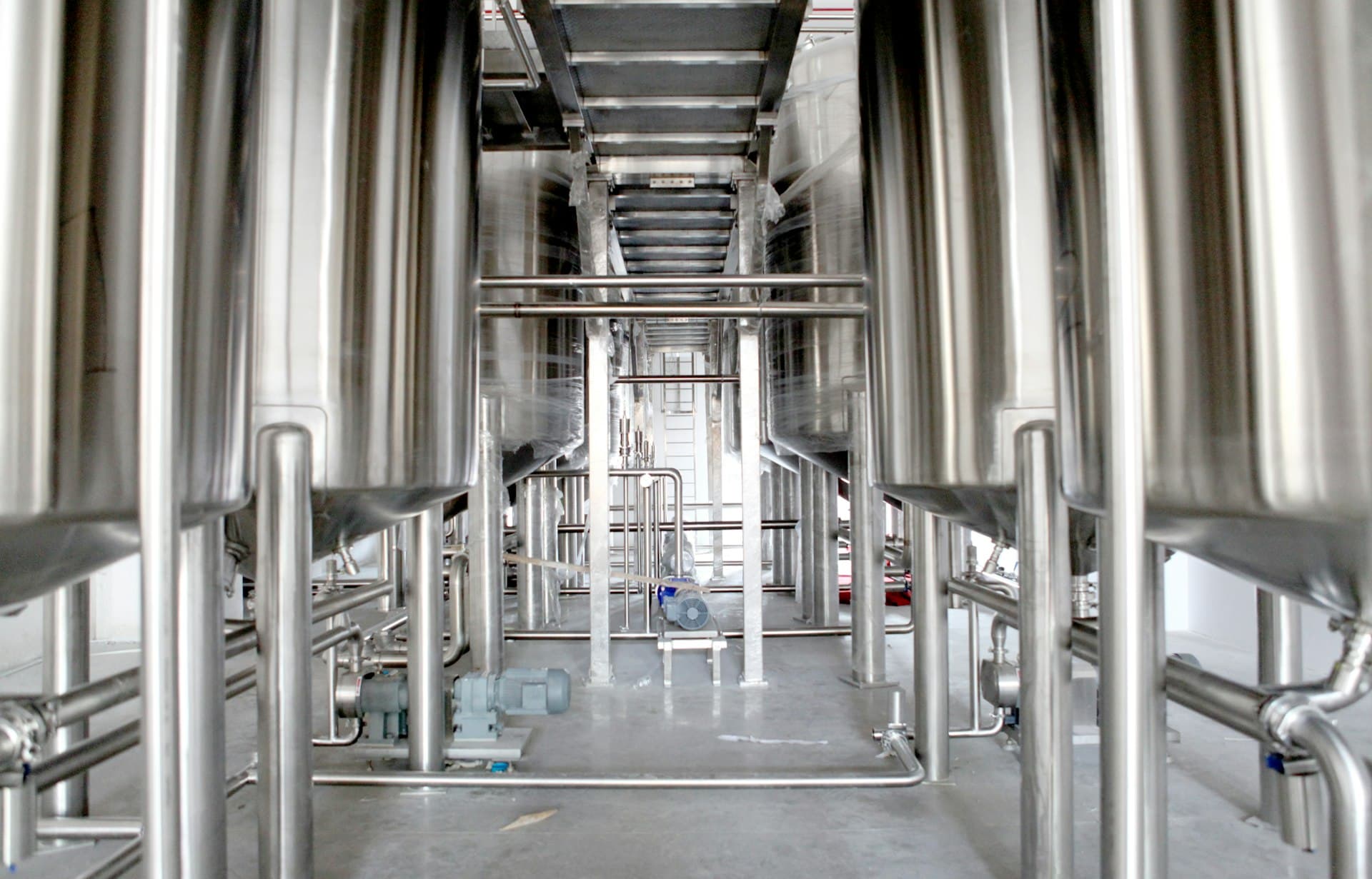 Bright corridor of stainless process equipment in a purified-water production hall