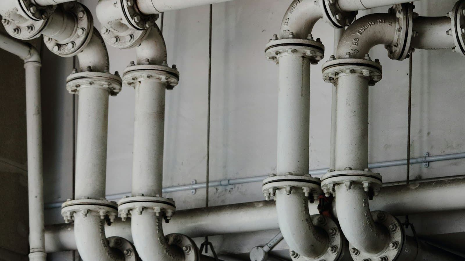 Industrial process piping and pumps inside a manufacturing plant, the infrastructure at the heart of an industrial water reuse system that recovers and recycles process water