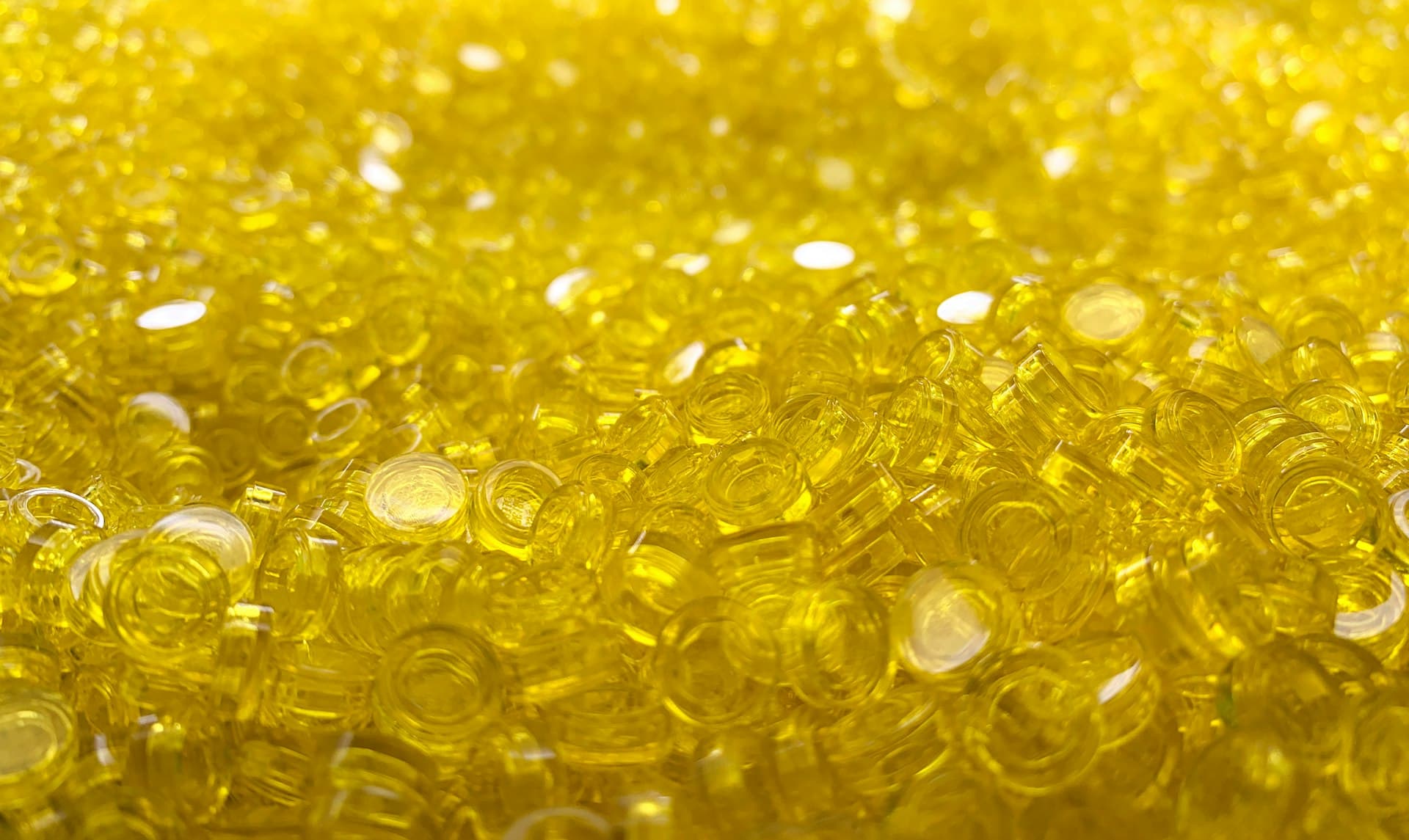 Macro view of amber ion-exchange resin beads that swap ions out of the water