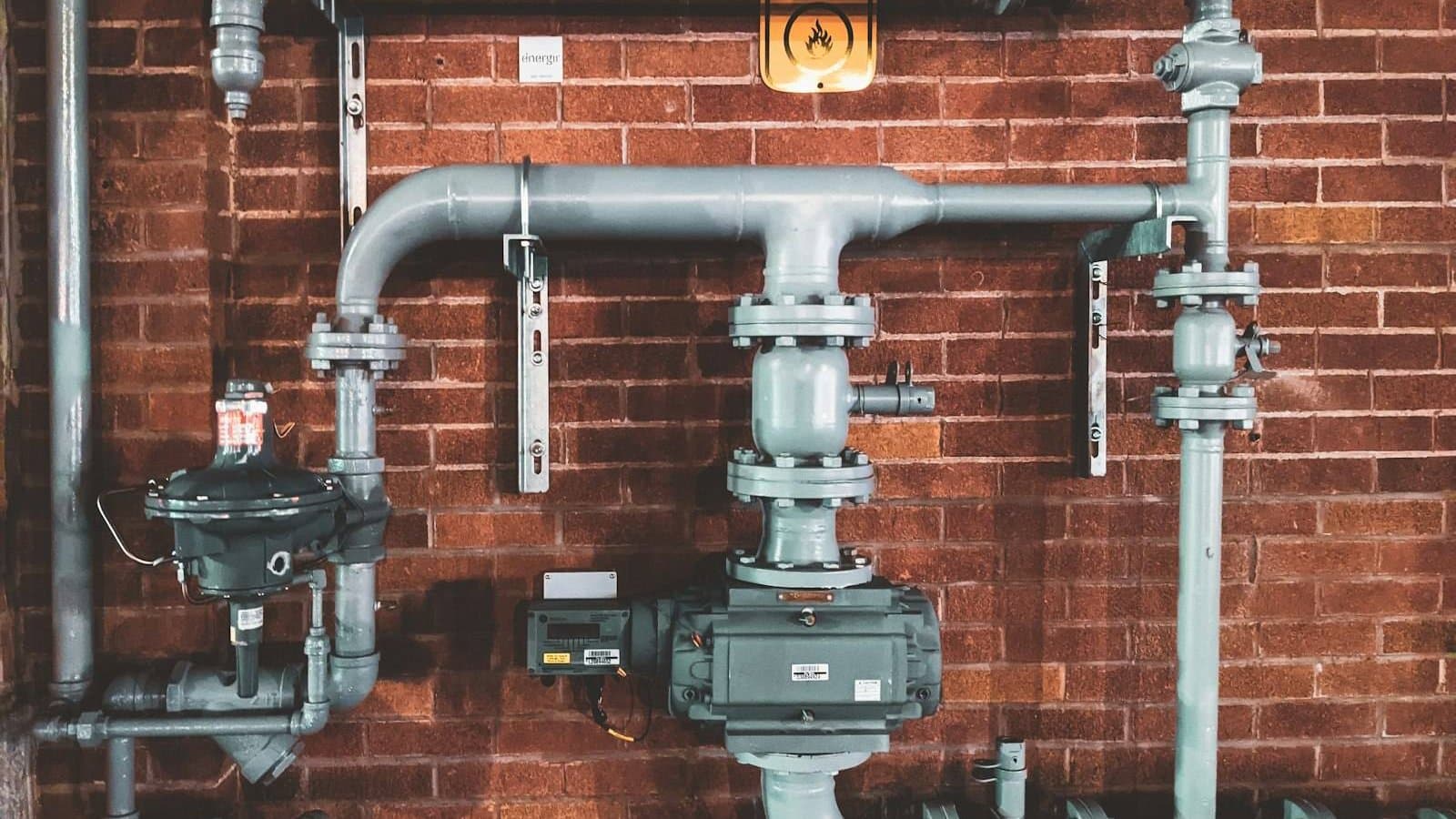 Black and gray metal pipe in an industrial setting, the pressurised pipework connecting membrane filtration modules across MF, UF, NF, and RO system configurations