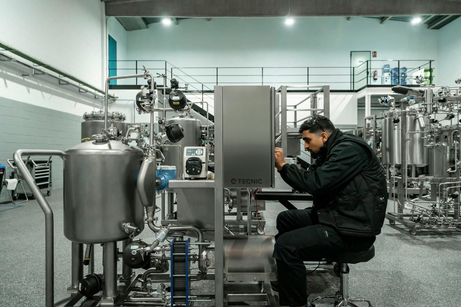 Engineer working at the control screen of a stainless membrane processing unit