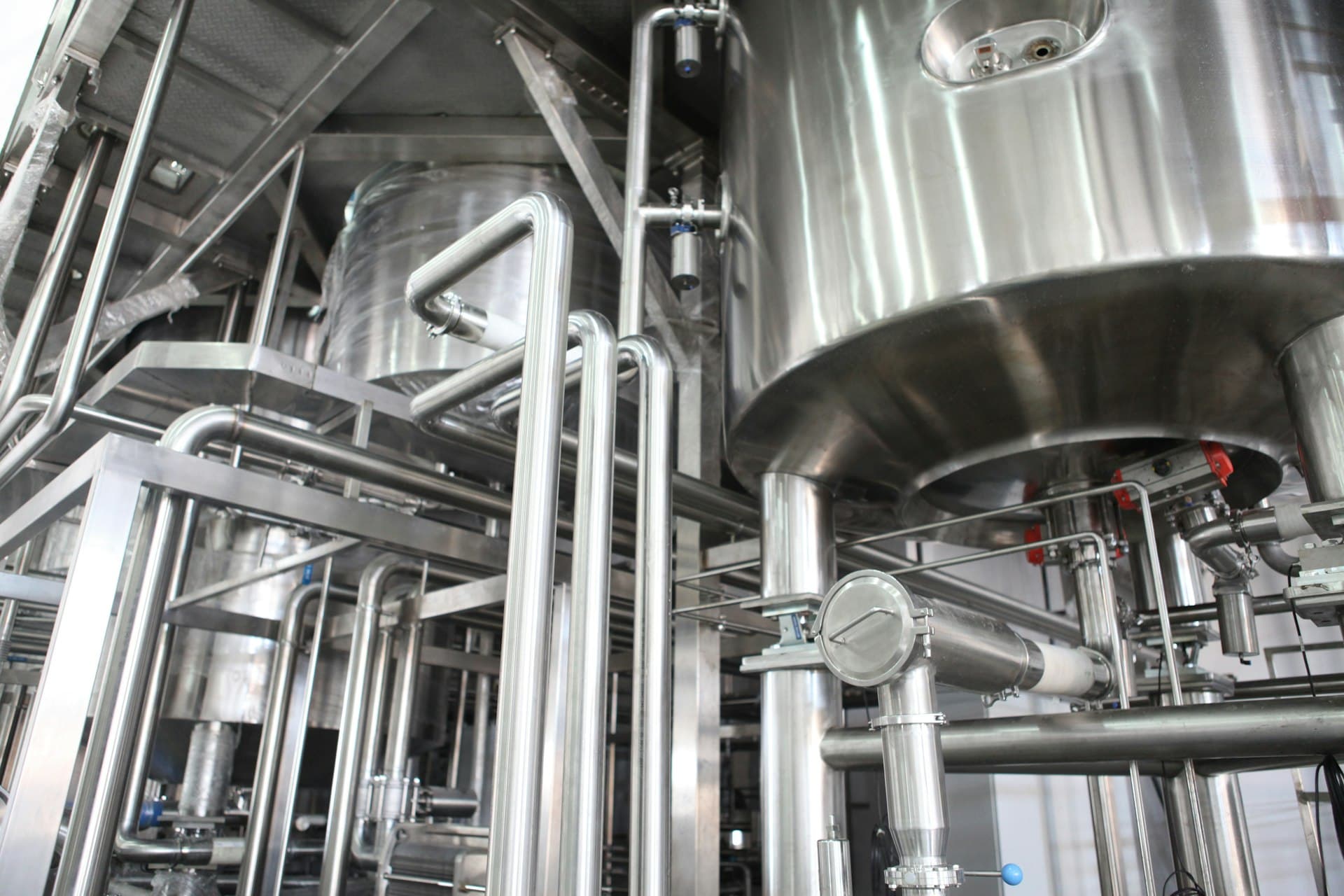 Gleaming stainless tanks and piping of a membrane plant kept clean by CIP and fouling control
