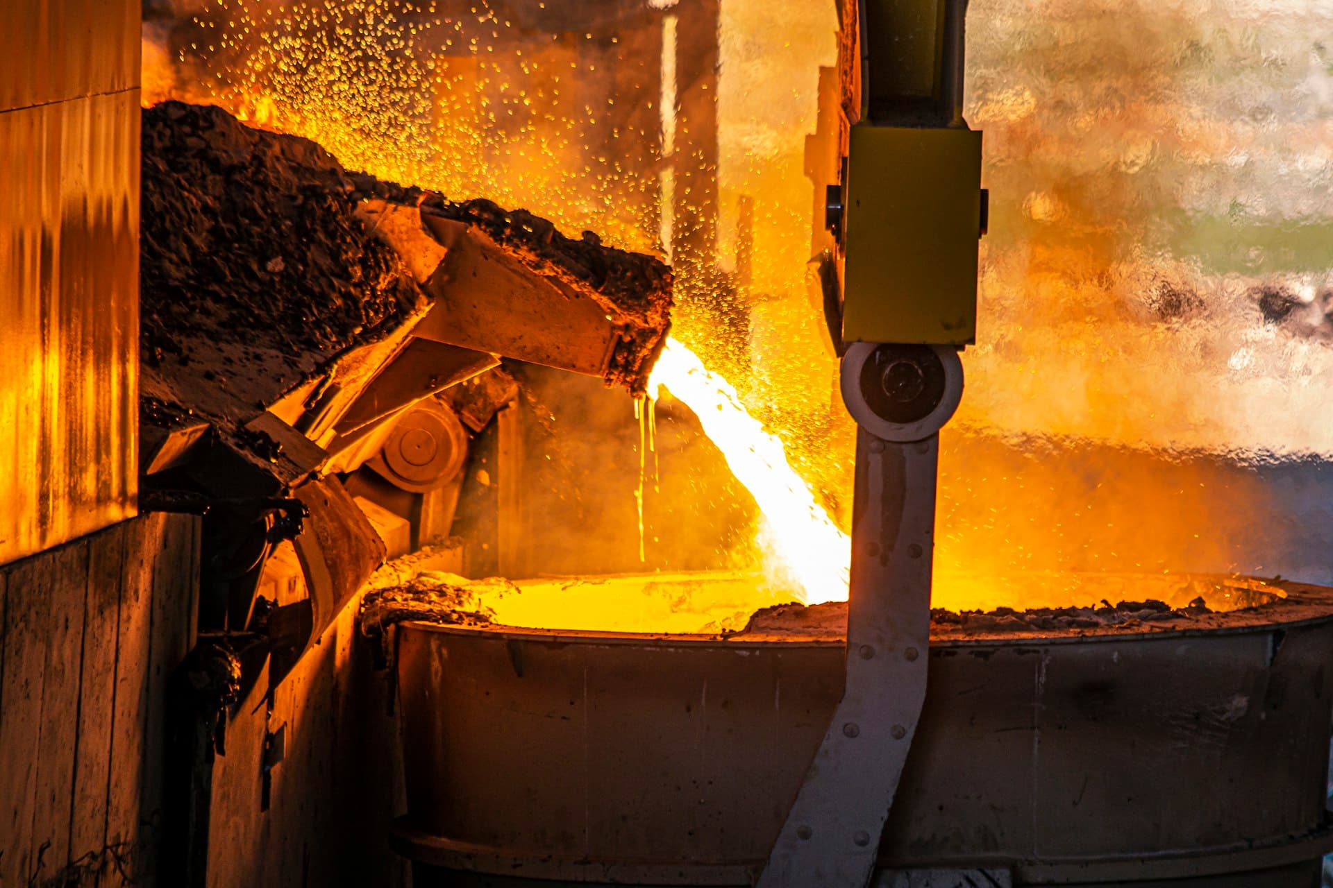 Molten metal pouring from a furnace ladle at a steelworks
