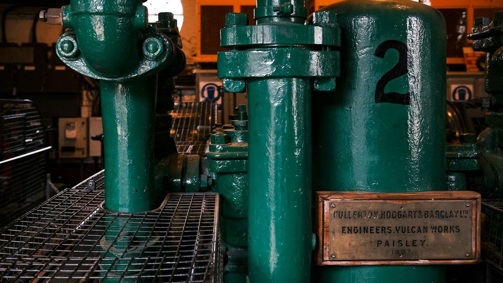 Group of green industrial pipes in a process plant, the pipe network through which oily wastewater flows from source to oil-water separator and downstream polishing stages