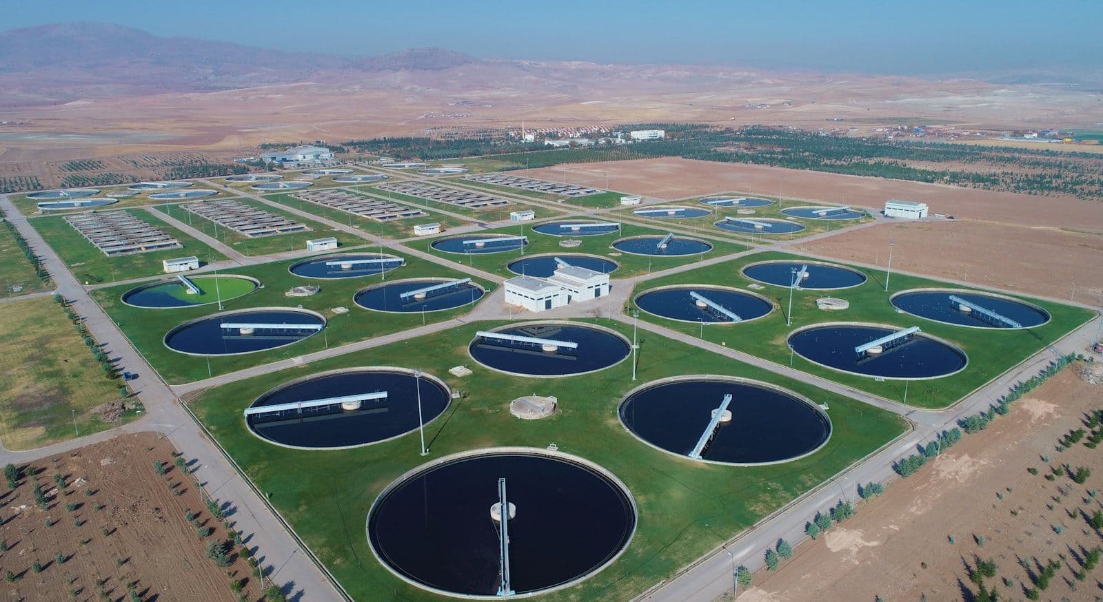 Aerial view of treatment basins at a large water plant — polishing steps like activated carbon target trace PFAS