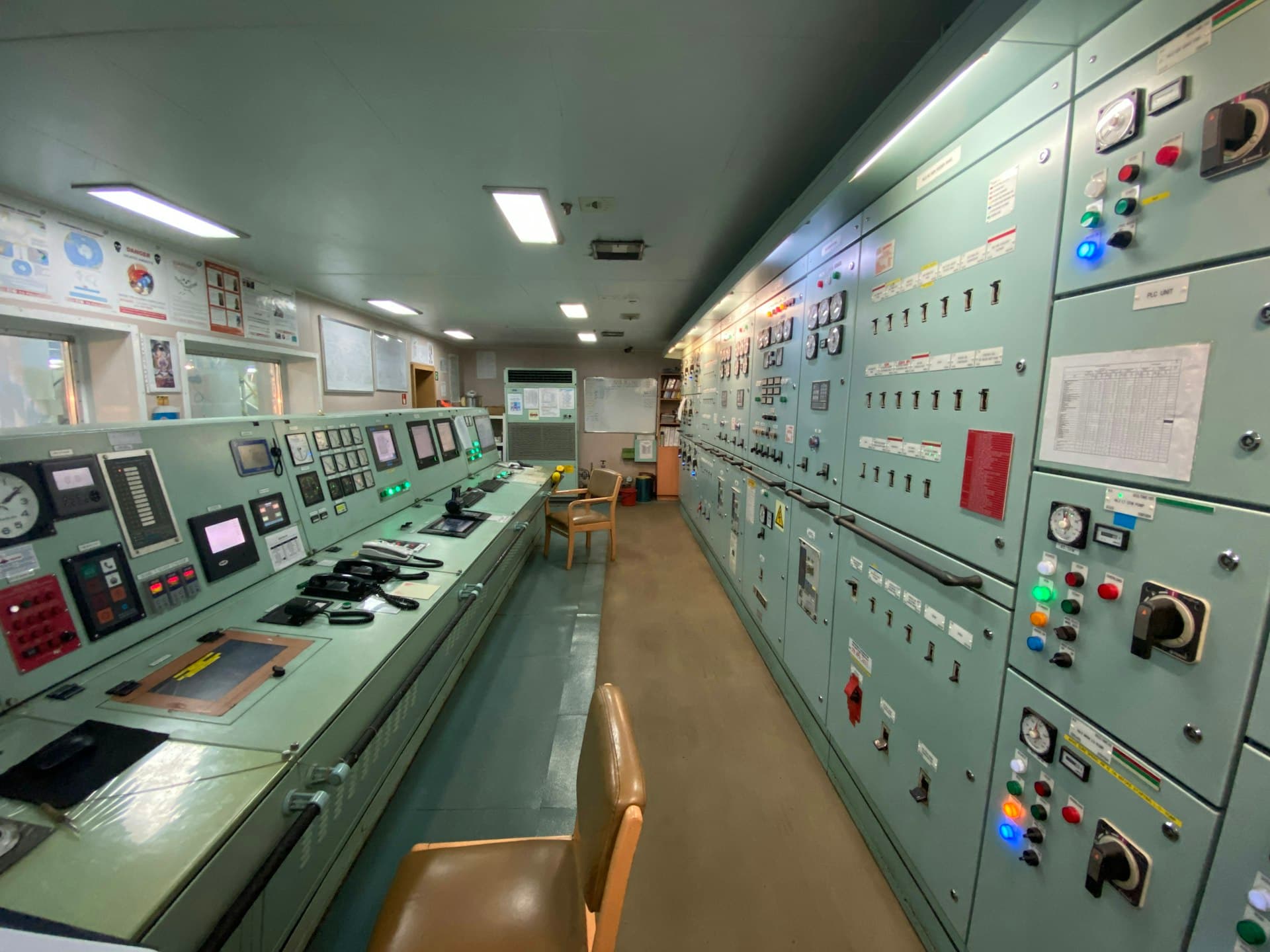 Control room lined with panels, indicators and switchgear — the physical layer under a SCADA system
