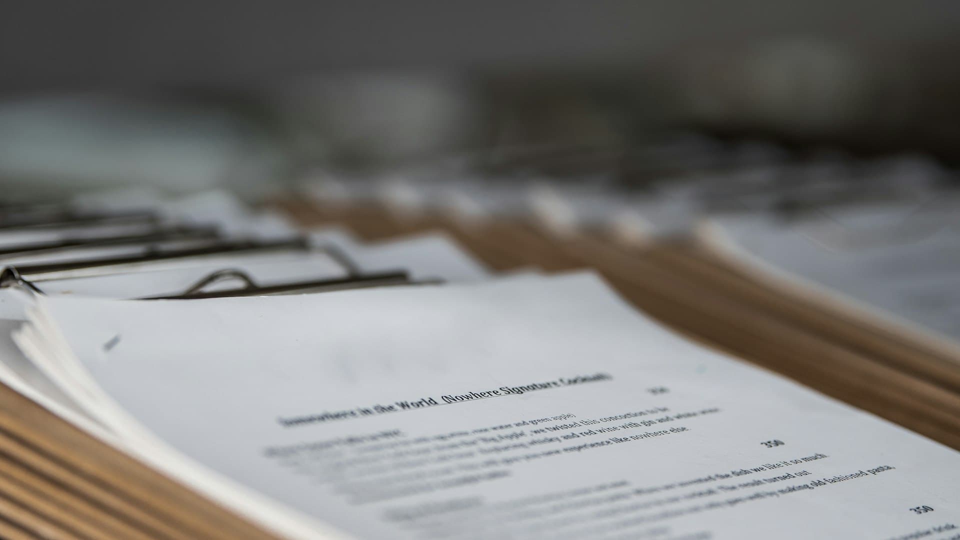 Stack of proposal documents on clipboards awaiting shortlisting