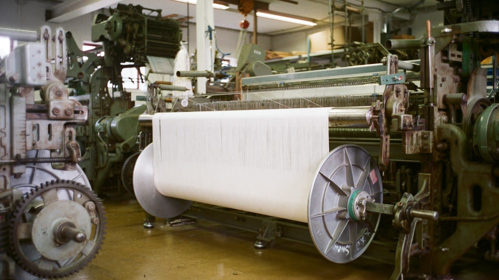 Coloured textile dye effluent flowing through an industrial treatment line, the high-chroma load that drives the technology selection for colour removal and reuse decisions