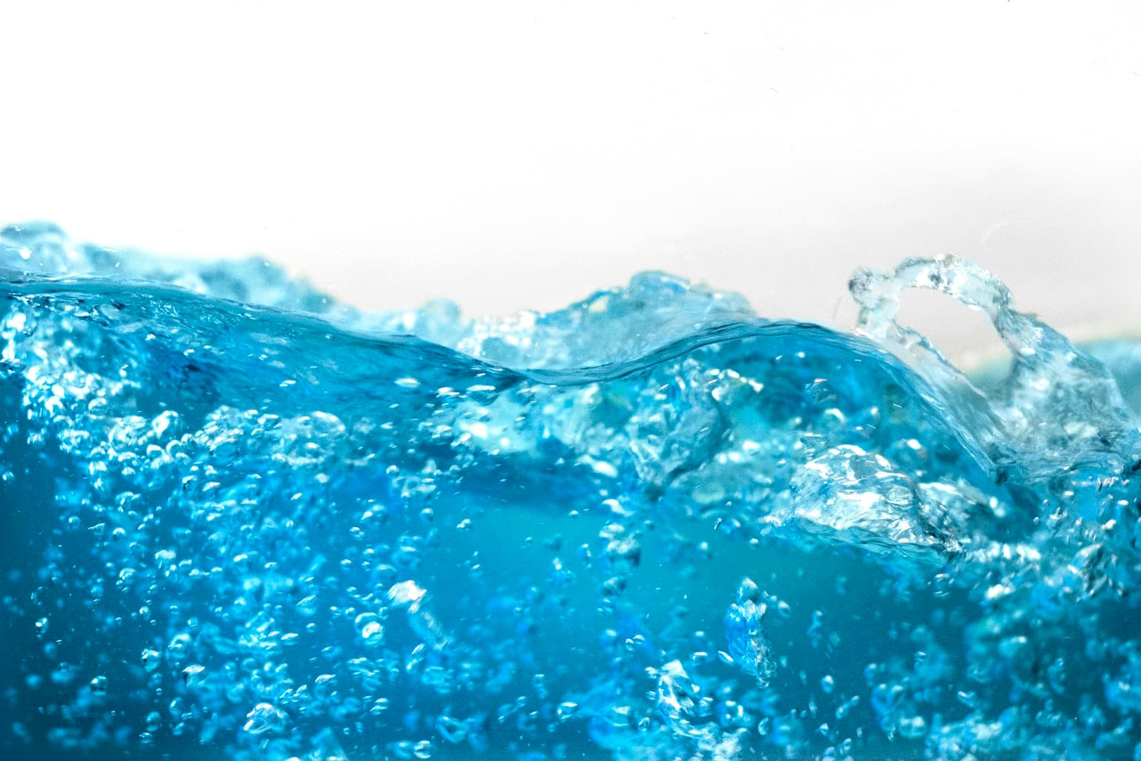 Blue water droplets and fluid stream representing the critical choice between ultraviolet disinfection and chlorination in industrial water treatment systems