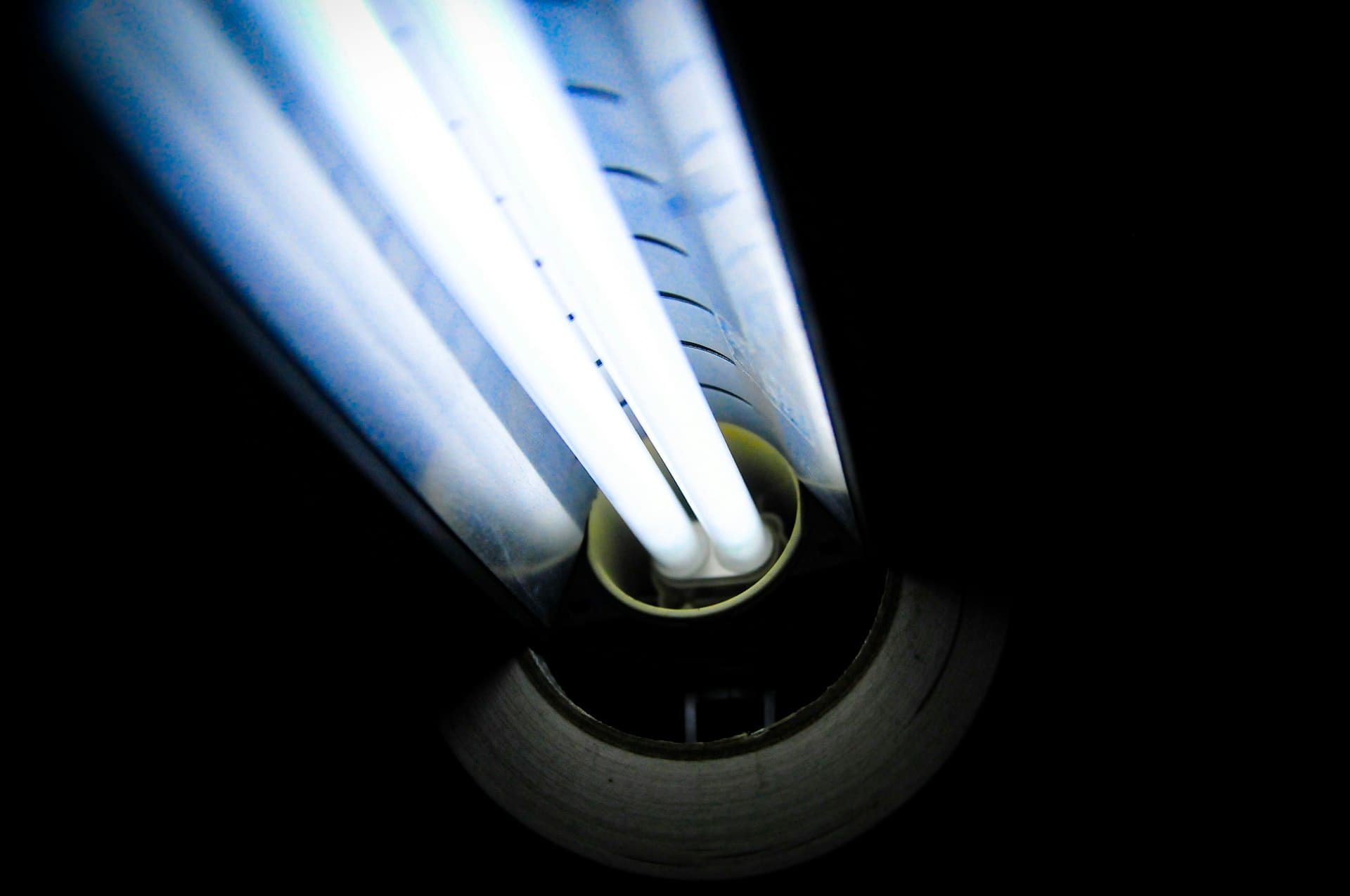 Close-up of a glowing ultraviolet tube — one of three disinfection chemistries compared