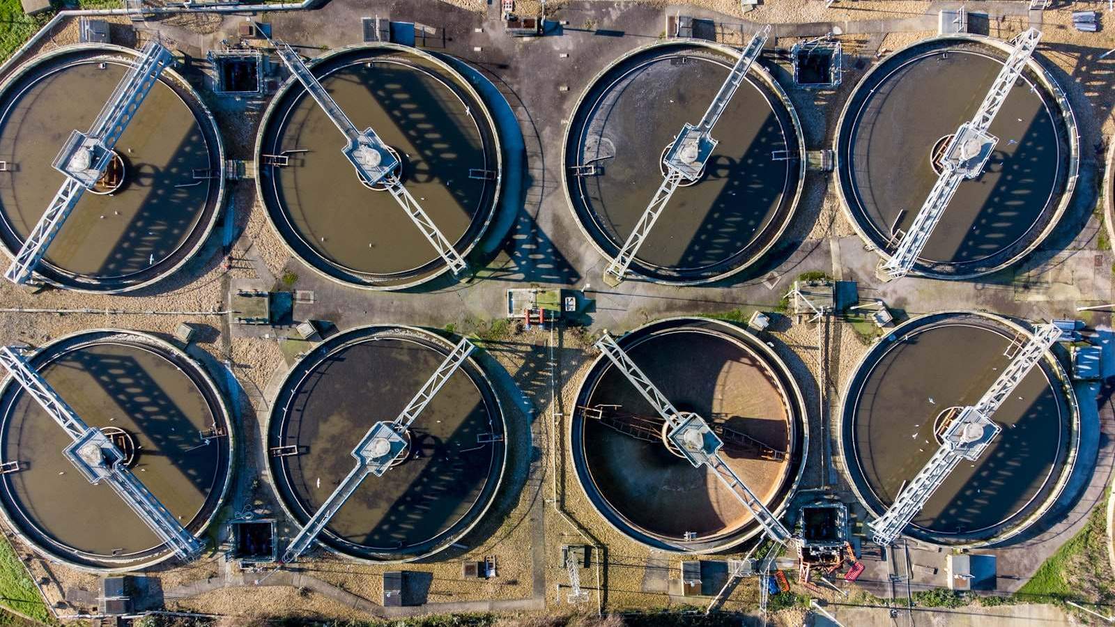 Large cylindrical industrial water storage tanks in an outdoor facility