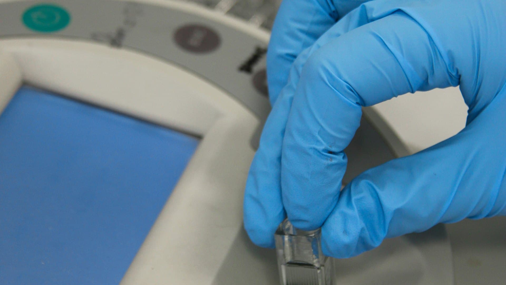 Technician logging readings from a handheld multiparameter water-quality probe directly at the tank