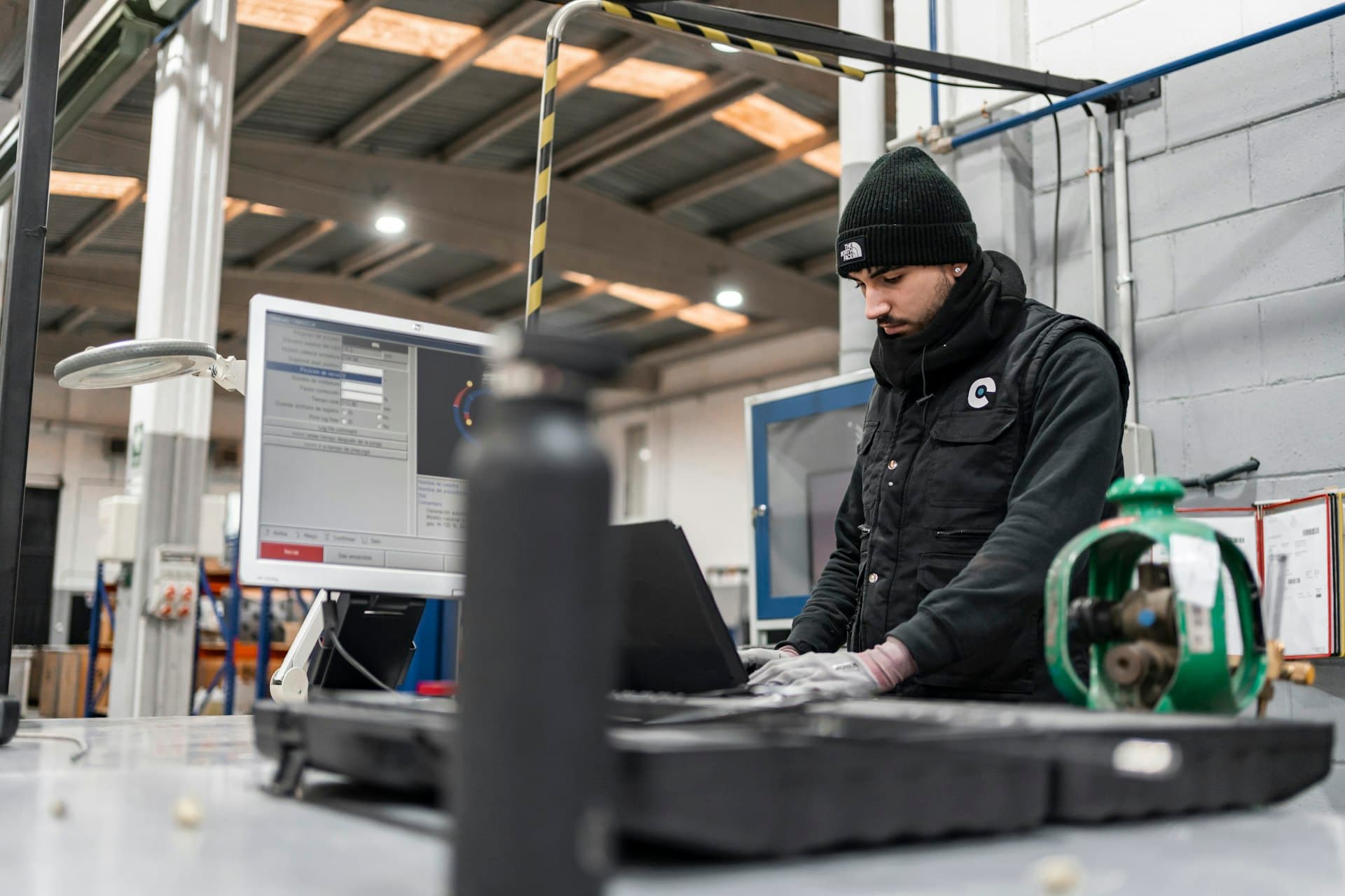 Technician working with diagnostic software at an industrial workstation
